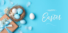 A Nest With Easter Eggs, A Gift And Feathers On A Blue Background.