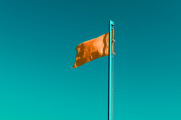 rescue orange flag against the sky