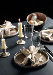 Wall Mural - easter, holidays, tradition and object concept - close up of dinner party table serving over black background