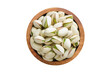 shelled pistachio nuts in wooden bowl isolated on white background. Vegan food, top view.