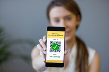 Qr Code Digital Green Pass Certificate For Coronavirus Vaccine With Bar Restaurant On Background - Focus On Woman Hand Holding Mobile Phone. Green Pass Certificate Of Vaccination On Smartphone
