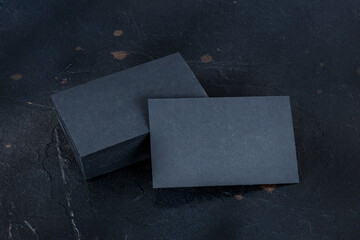 Wall Mural - Black business card mockup on a dark background, a template for design presentation, thick cardboard