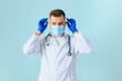 © Serhii - Male doctor in medical mask on color background