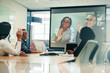 © Jacob Lund - Team of colleagues greeting their business associates during a virtual meeting