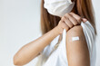 © 9nong - Healthy and strong asian woman getting vaccinated immunity by vaccination program, concept of recommended dose of inoculation, vaccine booster shot, vaxxed woman with approved vaccine