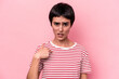 © Asier - Young caucasian woman isolated on pink background surprised pointing with finger, smiling broadly.