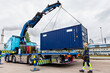 © Johnér - Woman assisting with carrying cargo container