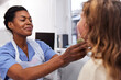 © Johnér - Female doctor examining girl patient's neck