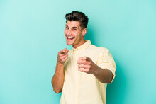 Young Caucasian Man Isolated On Blue Background Cheerful Smiles Pointing To Front.