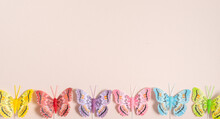 Multicolored Handmade Butterflies On A Pale Pink Background, Free Space For Text, Elegant Spring Composition