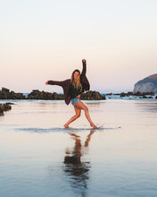 Cheerful Woman Dancing On Wet Beach