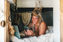 Cheerful Woman Browsing Smartphone In Camper Van