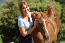 Happy Woman Beside A Horse Looking At You