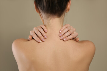 Poster - Back view of woman with perfect smooth skin on beige background, closeup. Beauty and body care