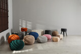 Fototapeta  - Many stylish different poufs in room. Home design