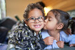 © Trevor Adeline/Caia Image - Portrait cute sister kissing brother in cheek