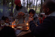 © Trevor Adeline/Caia Image - Family eating at candlelit table