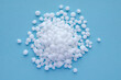 © aneriksson - Urea granules on a blue background, space for text, top view. Nitrogen mineral fertilizer - urea. Ammonium nitrate, a salt of ammonia and nitric acid, is used for plant nutrition, top view.