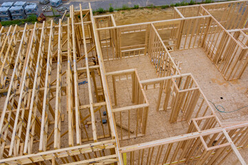 A long of installing second floor joists in a new apartment development under construction.