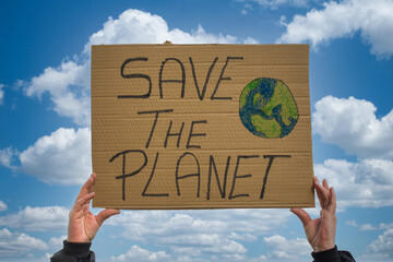A Closeup Shot Of A Person Holding A Sign That Says Save The Planet, On A Sky Background