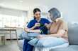 © Kawee - Asian caregiver doctor examine older patient use blood pressure gauge.