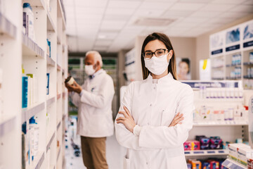 A successful female pharmacy worker waiting for patients during covid.