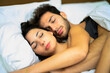 © Minerva Studio - Young couple cuddling and sleeping under the blankets