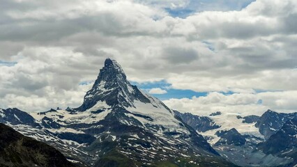 Wall Mural - Scenic view of Matterhorn mountain peak dramatic overcast with dark heavy clouds, Zermatt, Switzerland.