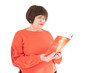© Sandra - old lady with glasses reading a book on white background