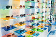 Different assortiment of UV protective eyewear frames on display panels in optical store. Select of functional sunglasses in local optic shop. Eyecare, vision concept