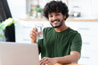 © kucherav - Happy young Indian man holding glass still mineral water, looks at the camera and smiles friendly. Healthy lifestyle concept
