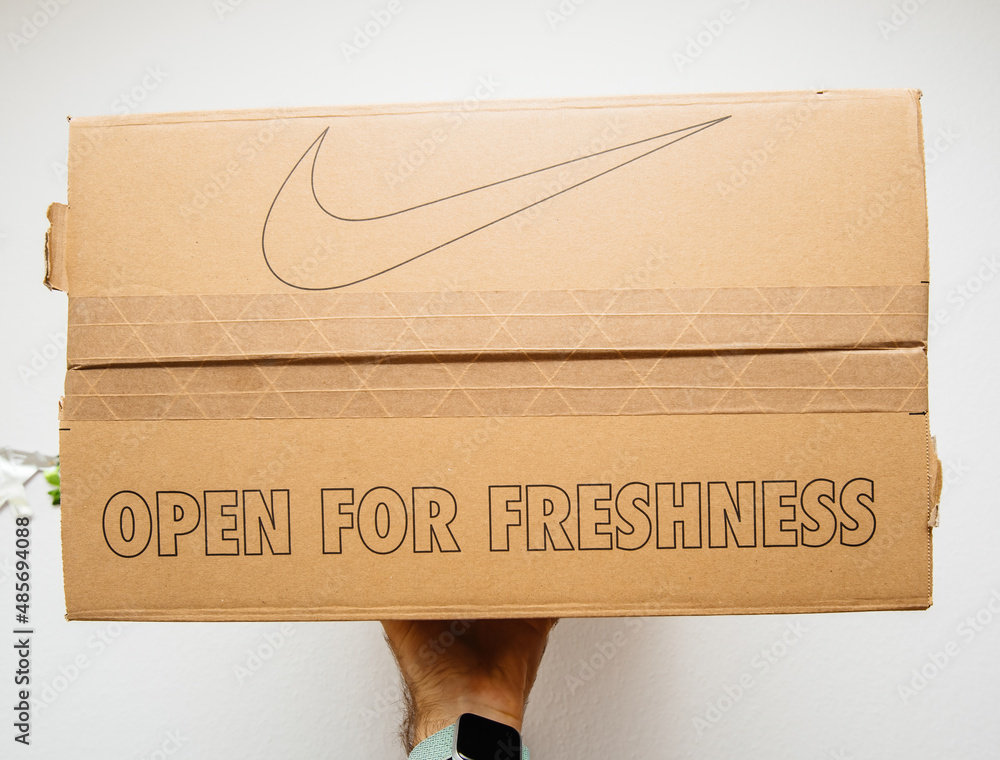 Open for freshness and Nike logotype on cardboard box with shoes Stock Photo Adobe Stock