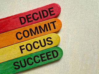 Wall Mural - Inspirational and Motivational Concept - DECIDE COMMIT FOCUS SUCCEED text on colourful wooden sticks background. Stock photo.