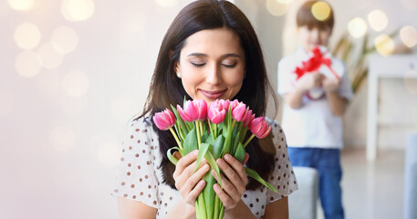 Poster - Happy woman with aromatic tulip flowers presented by her son for International Women's Day at home