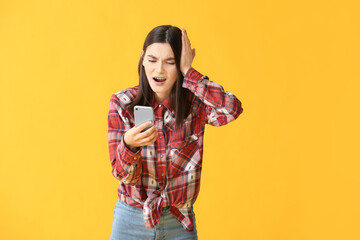 Sticker - Troubled young woman with mobile phone on color background