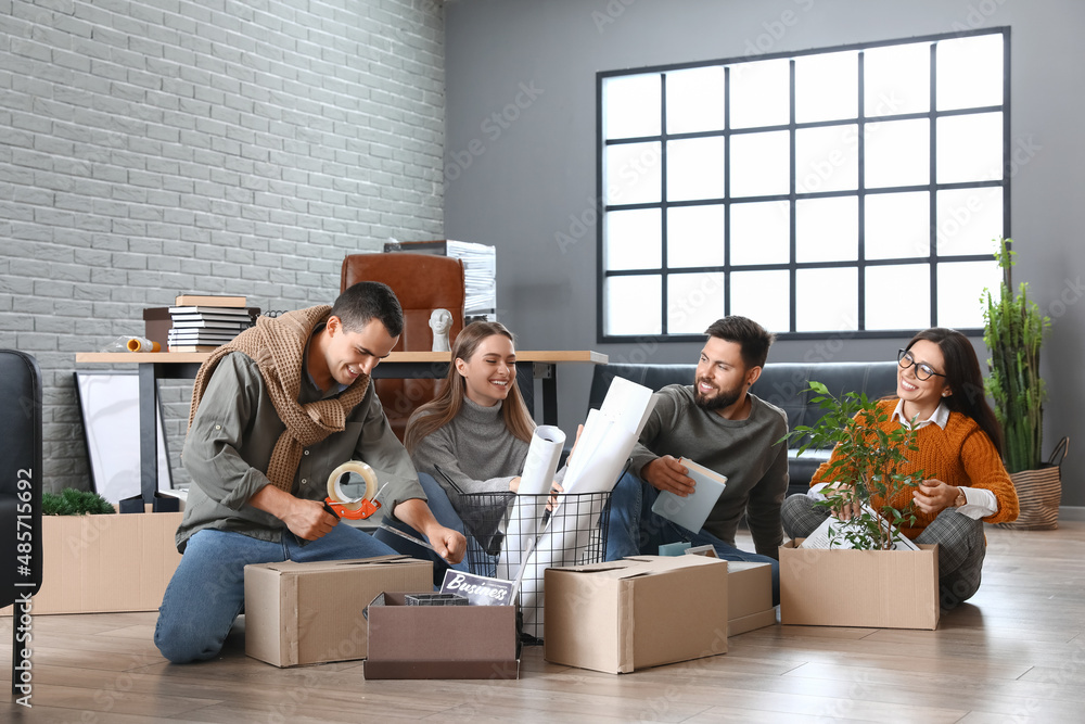 Business people packing stuff in office on moving day