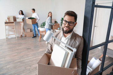 Sticker - Handsome man holding box with personal things in office on moving day