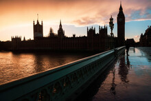 Houses Of Parliament (Palace Of Westminster) And Big Ben Silhouetted At Sunset, Seen From Westminster Bridge, London, England