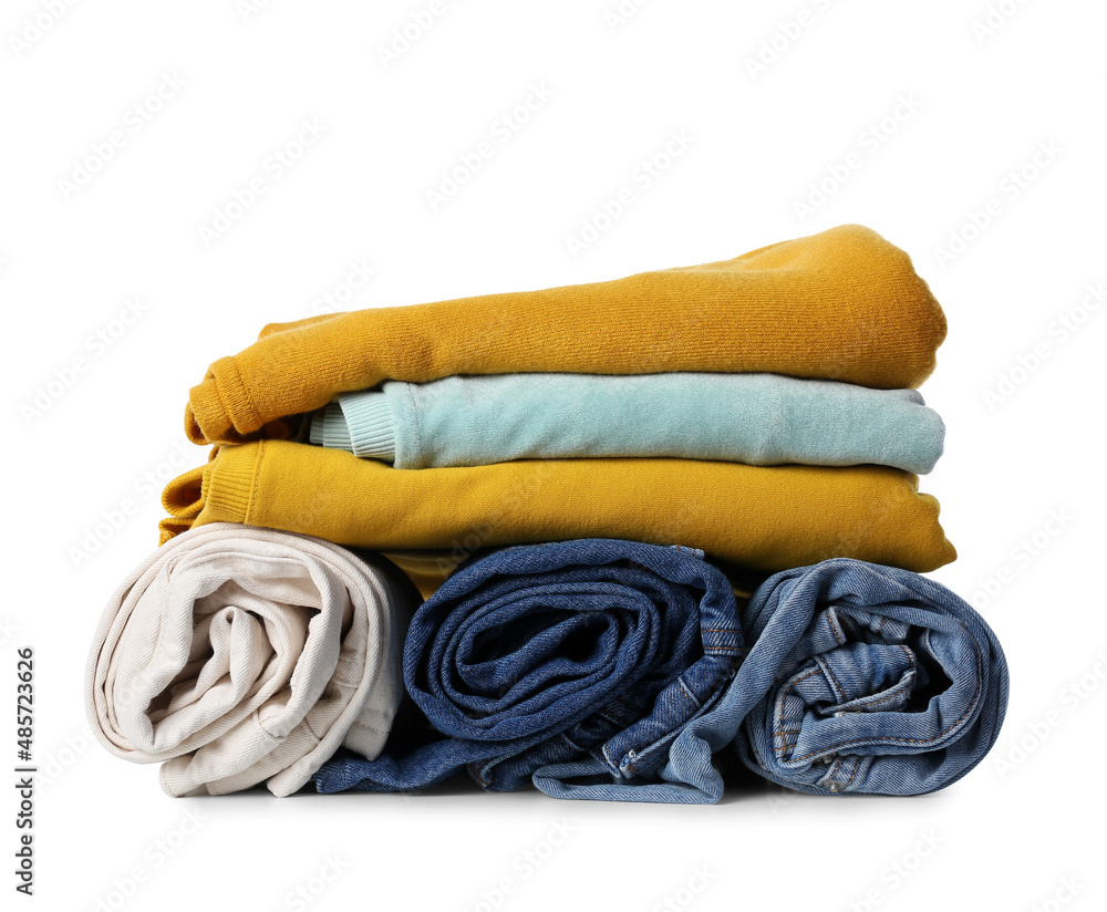 Different female sweaters and jeans on white background