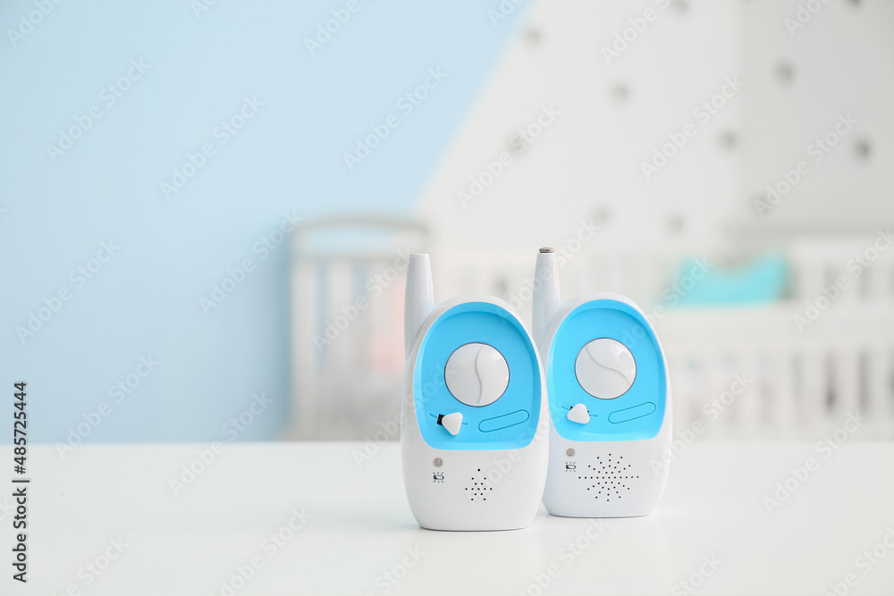 Modern baby monitors on table in room