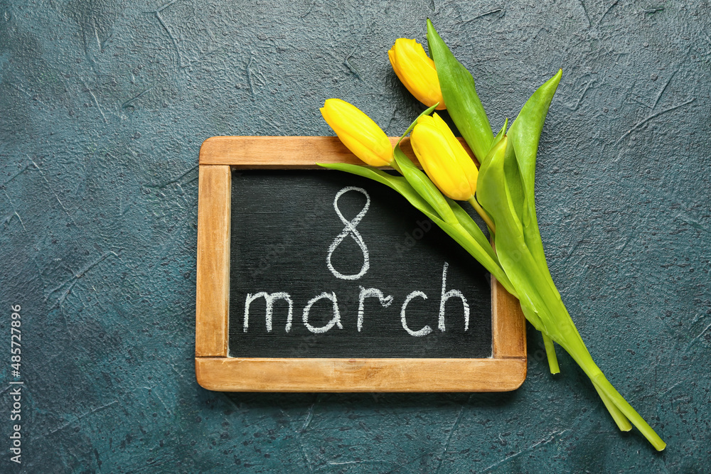 Chalkboard with text 8 MARCH and tulip on dark background. International Women's day
