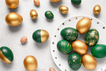 Canvas Print - Plate with stylish Easter eggs  on light background