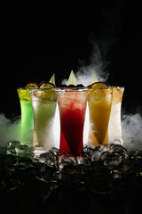 Canvas Print - A beautiful shot of a various cocktails surrounded with ice cubes