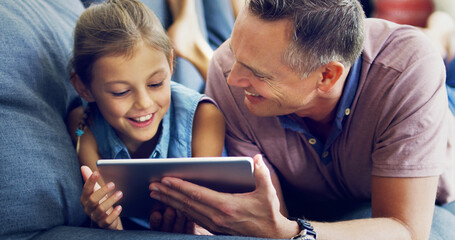 Poster - Lessons from dad in online safety. Shot of a cute little girl using a digital tablet with her father on the sofa at home.