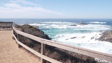 Rocky craggy ocean beach. Big waves crashing on cliff, water splashing, sea foam. Power of nature near Big Sur, 17-mile drive. Point Lobos seascape, Monterey, California coast, USA. Trail for hiking.