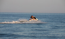 Teen Age Boy Skiing On Water Scooter. Young Man On Personal Watercraft In Tropical Sea. Active Summer Vacation For School Child. Sport And Ocean Activity On Beach Holiday