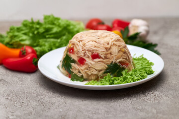 Delicious chicken aspic on a plate on concrete table