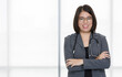 © Bangkok Click Studio - Portrait shot of Asian professional experienced friendly female doctor in formal suit jacket eyeglasses and stethoscope standing smiling crossed arms look at camera in emergency ward room hospital
