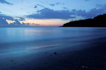 Wall Mural - Long Exposure of Waves and the Cool Blue Colours of Sunset at Nippah Beach, Lombok, West Nusa Tenggara, Indonesia, Asia, background with copy space