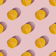 Uniform Pattern Of Dried Lemon Slices With Shadow On A Pink Background. Flat Lay